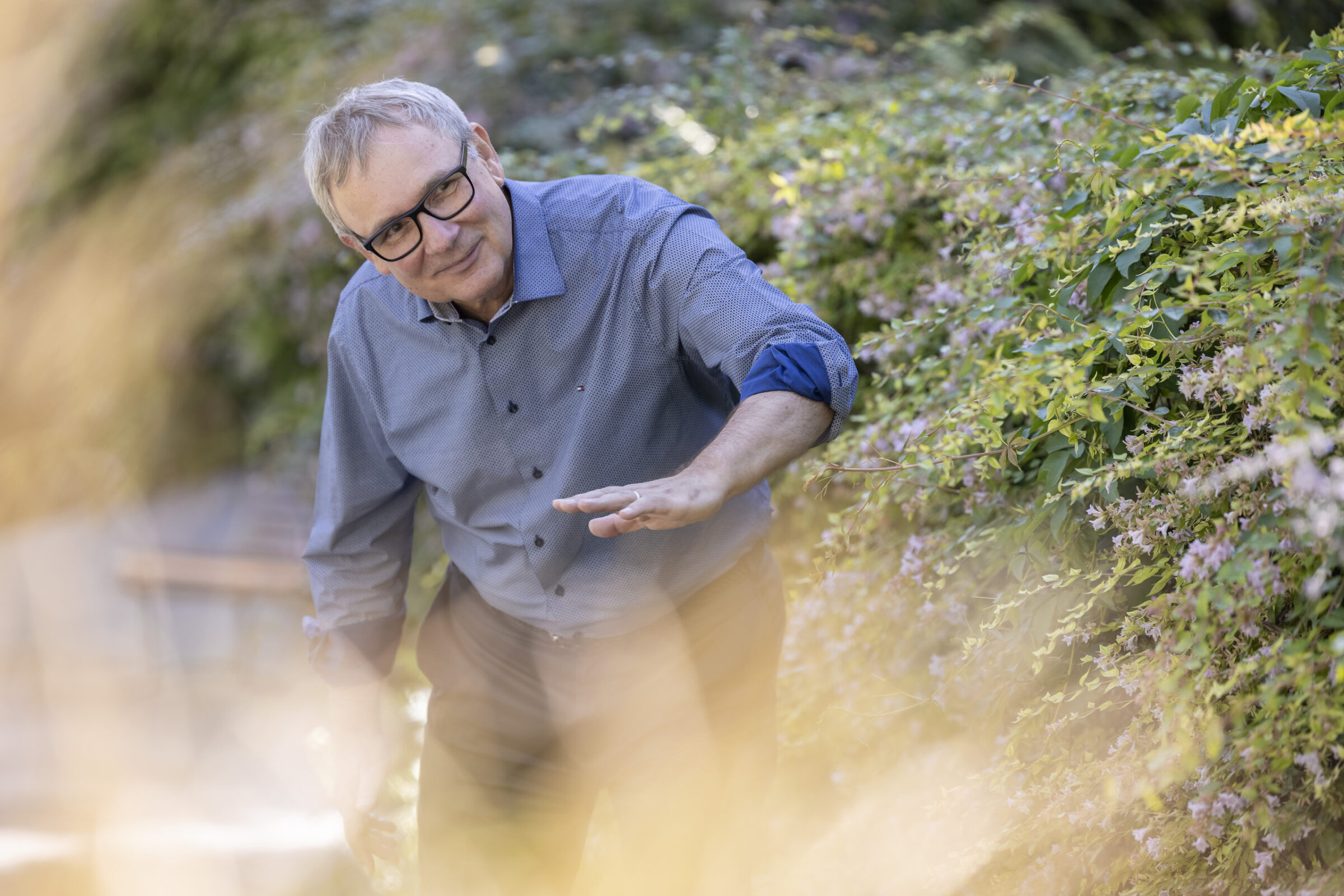 A man surrounded by greenery