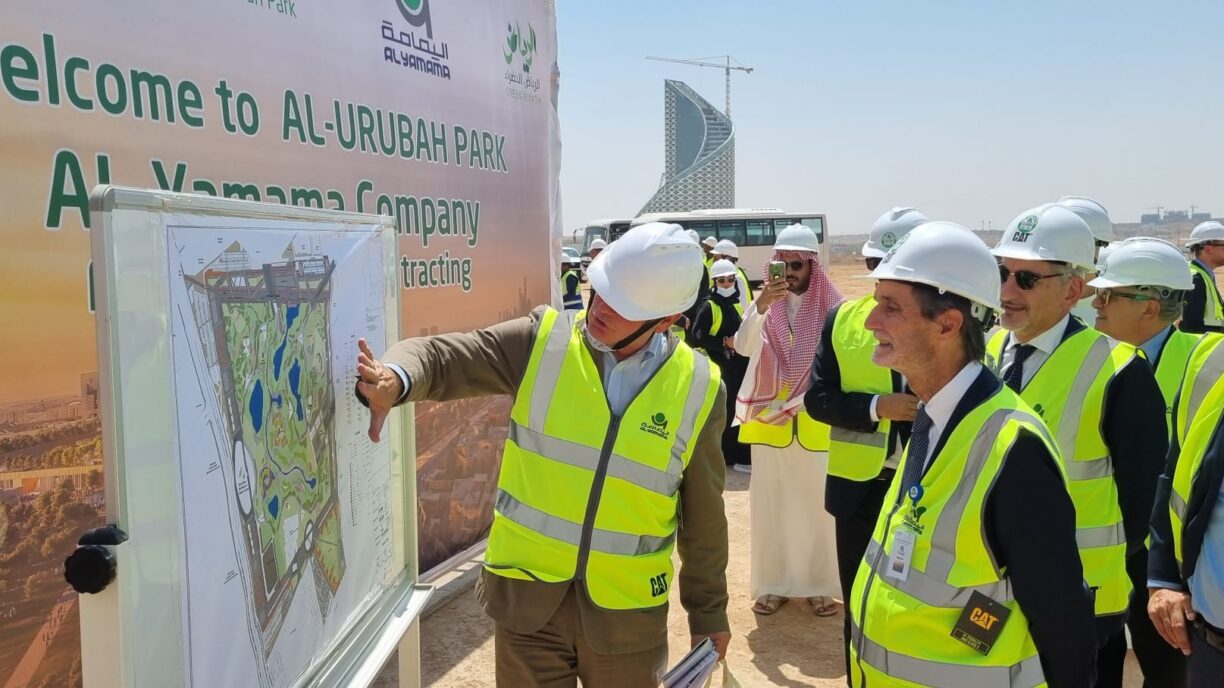 A man shows the map of a park to other people