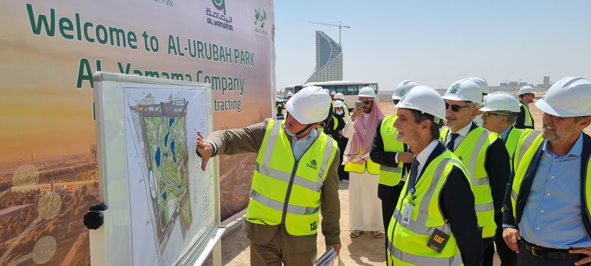 A man shows the map of a park to other people