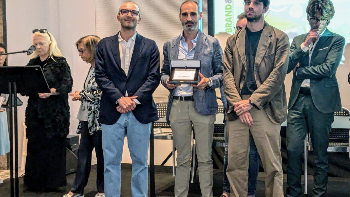 Three people holding an award