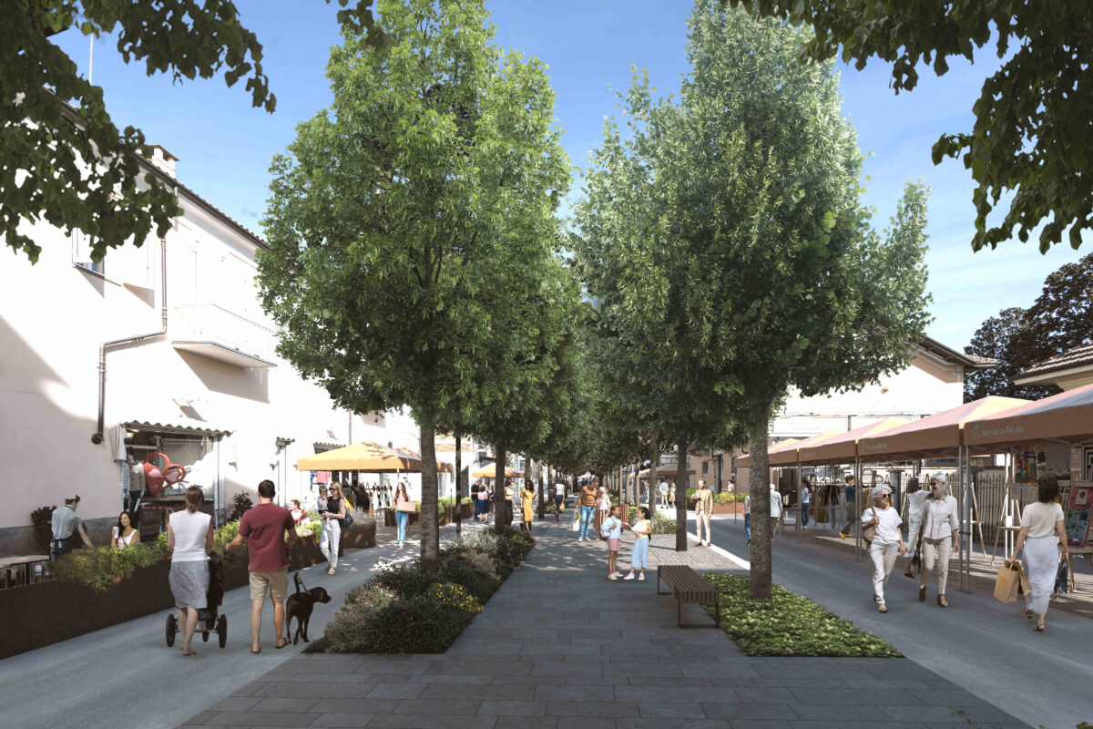 A shaded avenue, people strolling, shops and restaurants at the side