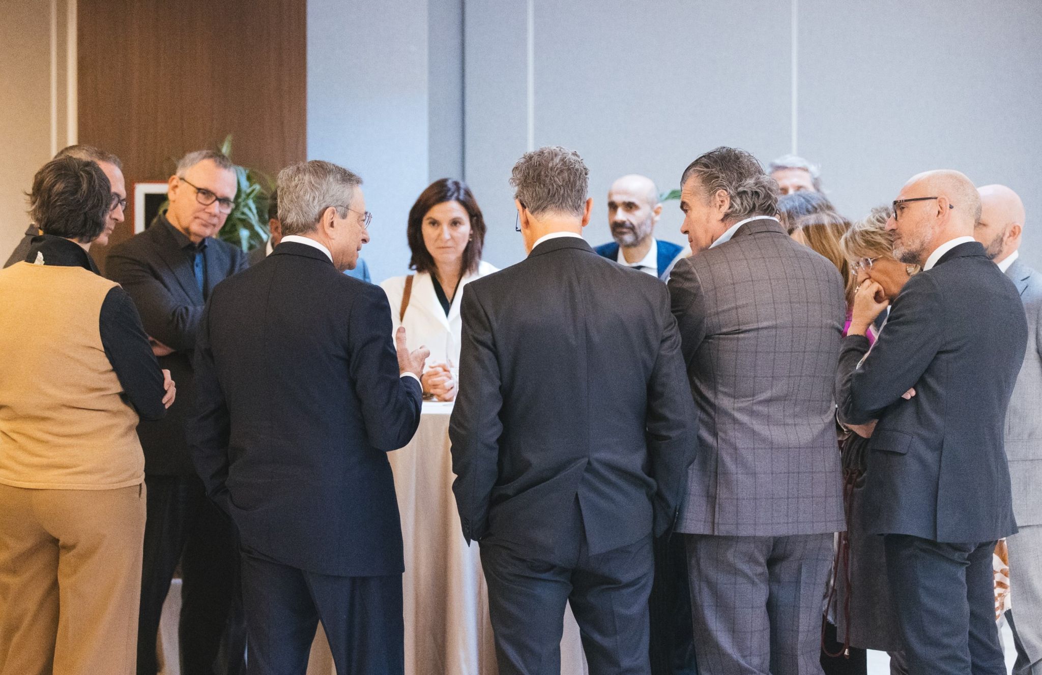 Group of elegantly dressed mainly male caucasians in a circle