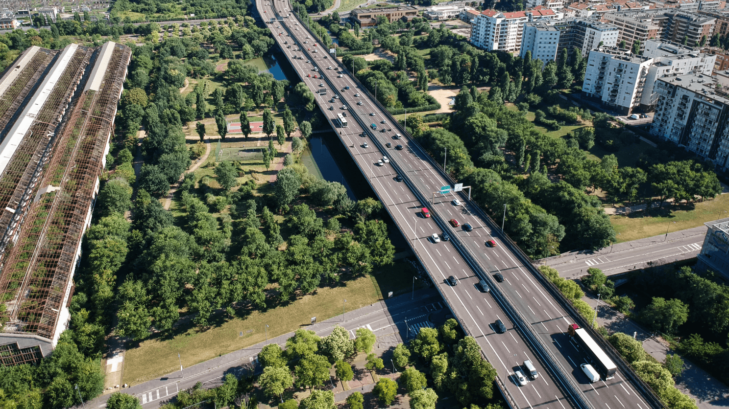 Aerial view of a highway, a green park and a neigbourhood